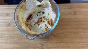 Toasted tortilla in a glass bowl on a wooden surface, perfect for wraps or dipping.