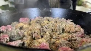 Sizzling ground beef in a skillet with spices, perfect for beef fajitas.