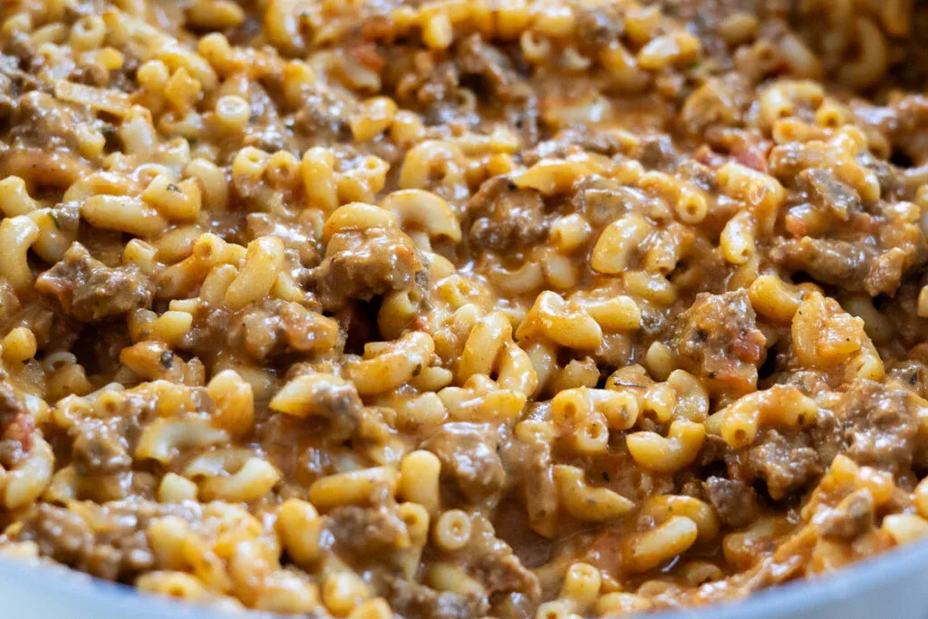 Creamy beef and macaroni pasta dish, richly seasoned and freshly cooked. Comfort food in a close-up shot.