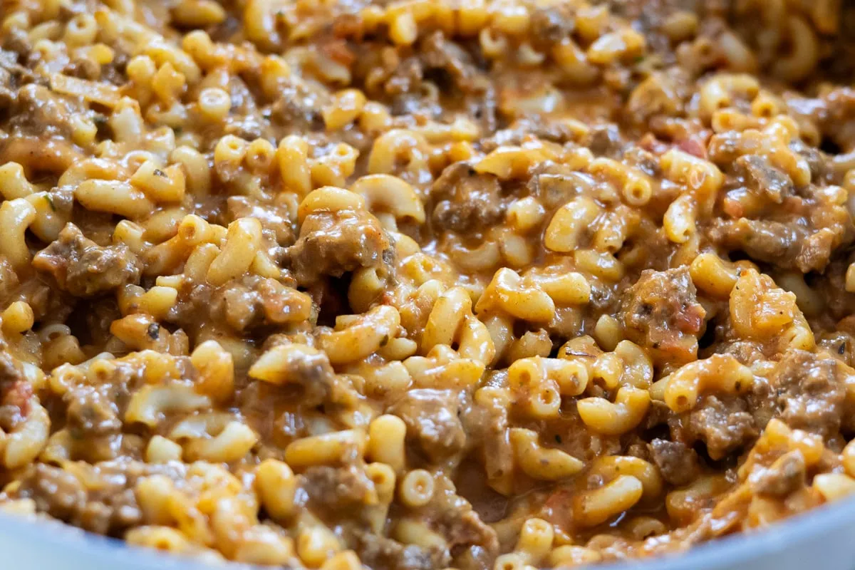 Creamy beef and macaroni pasta dish, richly seasoned and freshly cooked. Comfort food in a close-up shot.