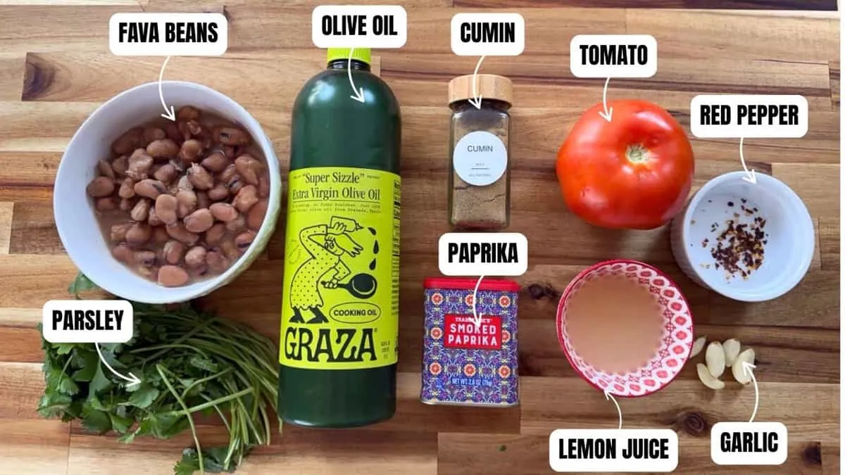 Ingredients for fava bean dish: fava beans, olive oil, cumin, tomato, paprika, red pepper, parsley, lemon juice, garlic.