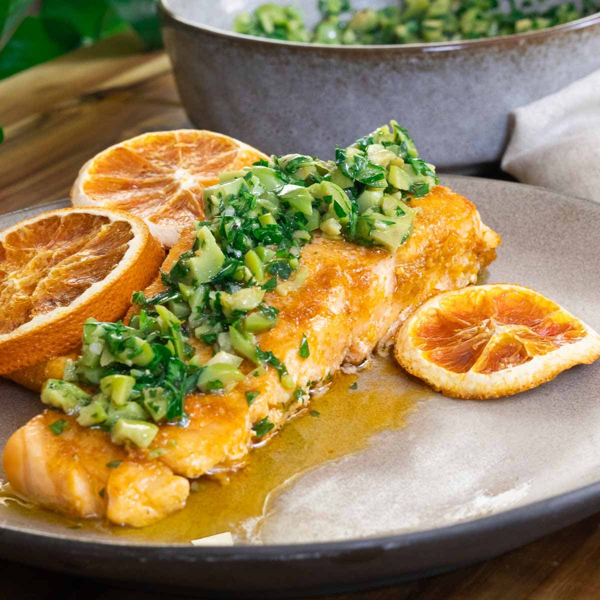 Salmon served with Gremolata and orange slices