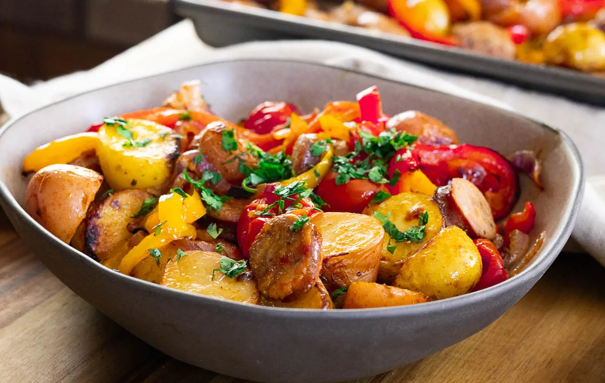 Rustic sausage, peppers, and potatoes in a bowl.