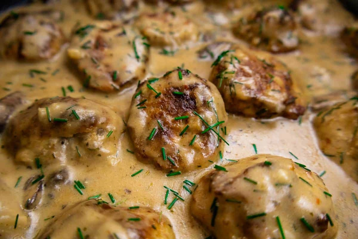 Savory chicken in creamy sauce garnished with fresh chives; delicious homemade comfort food.