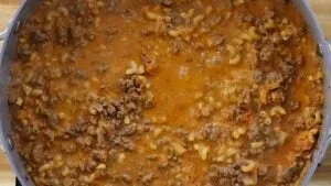 Close-up of homemade beef macaroni in a pot, featuring ground beef, pasta.